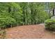 Large backyard surrounded by trees, with a fence, offering a private outdoor space at 6100 Blackwater Trl, Atlanta, GA 30328