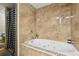 Elegant bathroom featuring a large soaking tub with jets, tiled walls and a shower at 6100 Blackwater Trl, Atlanta, GA 30328