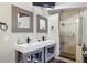 Modern bathroom featuring double sinks with sleek fixtures, a glass-enclosed shower, and updated design at 6100 Blackwater Trl, Atlanta, GA 30328