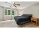 Cozy bedroom with a ceiling fan, large window, and neutral carpet at 6100 Blackwater Trl, Atlanta, GA 30328