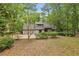 Charming home featuring stone accents, lush landscaping, and an attached garage nestled amongst mature trees at 6100 Blackwater Trl, Atlanta, GA 30328