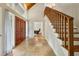 Grand foyer with high ceilings, tile floors, wood staircase, and beautiful natural light at 6100 Blackwater Trl, Atlanta, GA 30328