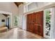 Welcoming foyer with double wood doors, tile flooring, and large windows providing natural light at 6100 Blackwater Trl, Atlanta, GA 30328