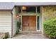 Inviting front entrance with double wood doors, stone accents, and sidelight windows at 6100 Blackwater Trl, Atlanta, GA 30328