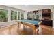 Game room featuring a pool table, hardwood floors, and ample natural light at 6100 Blackwater Trl, Atlanta, GA 30328