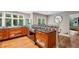 Open-concept kitchen featuring wood cabinets, stainless steel appliances, and an eat-in bar area at 6100 Blackwater Trl, Atlanta, GA 30328