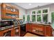 Modern kitchen with wood cabinets, granite countertops, and stainless steel appliances at 6100 Blackwater Trl, Atlanta, GA 30328
