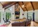 Open living room with vaulted ceilings, stone fireplace, and large windows showcasing natural light at 6100 Blackwater Trl, Atlanta, GA 30328