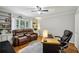 Bright office space with hardwood floors, built-in bookshelves, and a comfortable leather sofa at 6100 Blackwater Trl, Atlanta, GA 30328