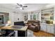 Well-lit office featuring hardwood floors, custom shelving, and a cozy seating area at 6100 Blackwater Trl, Atlanta, GA 30328