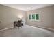 Versatile room featuring neutral carpet, a window with green outdoor view and a table with chair at 6100 Blackwater Trl, Atlanta, GA 30328