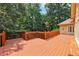 Open back deck with wood railings overlooking the wooded backyard at 8110 Lakemont Close, Mcdonough, GA 30253