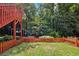 This backyard features a cute playset and a quaint fence with ample space to play or relax at 8110 Lakemont Close, Mcdonough, GA 30253