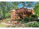 Expansive backyard featuring multi-level deck, lush landscaping, and room for outdoor activities at 8110 Lakemont Close, Mcdonough, GA 30253
