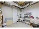 Unfinished basement storage area with white painted walls and drop lighting at 8110 Lakemont Close, Mcdonough, GA 30253