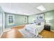 Inviting bedroom featuring hardwood floors, neutral decor, and lots of natural light at 8110 Lakemont Close, Mcdonough, GA 30253