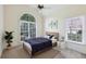 Bright bedroom features a large arched window, a bed and nightstand at 8110 Lakemont Close, Mcdonough, GA 30253