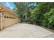 Exterior showcasing a long driveway leading to a brick home with mature trees and greenery at 8110 Lakemont Close, Mcdonough, GA 30253