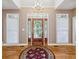 Elegant foyer with hardwood floors, chandelier, and decorative glass door creating a grand entrance at 8110 Lakemont Close, Mcdonough, GA 30253