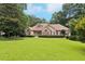 Classic brick home with manicured lawn, providing a welcoming and picturesque view at 8110 Lakemont Close, Mcdonough, GA 30253