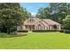 Beautiful brick home with well-maintained lawn and mature trees provides curb appeal at 8110 Lakemont Close, Mcdonough, GA 30253
