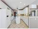 White kitchen with modern appliances and island at 8110 Lakemont Close, Mcdonough, GA 30253