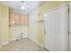 Bright laundry room features upper cabinets, white shelves and tile flooring at 8110 Lakemont Close, Mcdonough, GA 30253