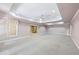Bright living room with neutral walls, recessed lighting, and access to the staircase at 8110 Lakemont Close, Mcdonough, GA 30253