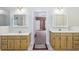 Neutral-toned main bathroom featuring dual vanities and doorway access at 8110 Lakemont Close, Mcdonough, GA 30253
