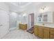 Main bathroom featuring dual sinks, large mirror, and glass shower at 8110 Lakemont Close, Mcdonough, GA 30253