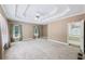 Large main bedroom features a tray ceiling, carpet, and neutral paint at 8110 Lakemont Close, Mcdonough, GA 30253