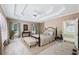 Spacious main bedroom with tray ceiling, bench, and ensuite bathroom at 8110 Lakemont Close, Mcdonough, GA 30253