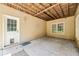 This covered patio includes a door with pet access, and a double window for natural light at 8110 Lakemont Close, Mcdonough, GA 30253