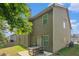 Backyard featuring a green lawn, a patio with a wooden table set, and the exterior of the home with neutral siding at 10137 Cormac St, Jonesboro, GA 30238