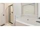 Bright bathroom with shower stall and soaking tub with modern finishes at 10137 Cormac St, Jonesboro, GA 30238