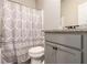 Cozy bathroom featuring granite counters, gray cabinets, and a shower/tub combo at 10137 Cormac St, Jonesboro, GA 30238