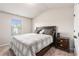 Neutral bedroom featuring carpeted floors, a queen bed with plaid bedding, and a view to the window at 10137 Cormac St, Jonesboro, GA 30238