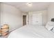 Bright bedroom with white walls, carpeted floors, a double door closet and a view to a hallway at 10137 Cormac St, Jonesboro, GA 30238