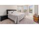 Well-lit bedroom with neutral decor, soft carpet, and large windows at 10137 Cormac St, Jonesboro, GA 30238