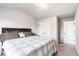 Neutral bedroom featuring carpeted floors, a queen bed with plaid bedding, and double door closet at 10137 Cormac St, Jonesboro, GA 30238