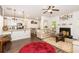 Open concept kitchen and living room with bar, wood floors and fireplace at 10137 Cormac St, Jonesboro, GA 30238