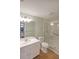 Bright bathroom with wood-look floors, updated vanity, and a glass-enclosed walk-in shower at 1800 Clairmont Lk # 313, Decatur, GA 30033