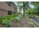 Beautifully landscaped gardens with hydrangeas and a seating area near the brick building at 1800 Clairmont Lk # 313, Decatur, GA 30033