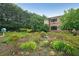 Landscaped gardens surrounding a building, showcasing vibrant flowers, shrubs, and trees at 1800 Clairmont Lk # 313, Decatur, GA 30033