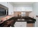 Well-lit kitchen featuring stainless steel appliances and black granite countertops at 1800 Clairmont Lk # 313, Decatur, GA 30033