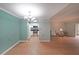 Open-concept living room with hardwood floors flowing to a kitchen with white cabinets at 1800 Clairmont Lk # 313, Decatur, GA 30033