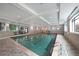 Bright indoor swimming pool with tiled flooring, recessed lighting, and multiple windows at 1800 Clairmont Lk # 313, Decatur, GA 30033