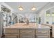 Open concept kitchen features a large island with seating and flows into the living area at 3111 Old Thompson Mill Rd, Buford, GA 30519