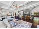 Inviting living room with a coffered ceiling, flowing into the kitchen, and a welcoming entryway at 3111 Old Thompson Mill Rd, Buford, GA 30519