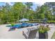 Swimming pool with lounge chairs and patio furniture, surrounded by trees at 3111 Old Thompson Mill Rd, Buford, GA 30519